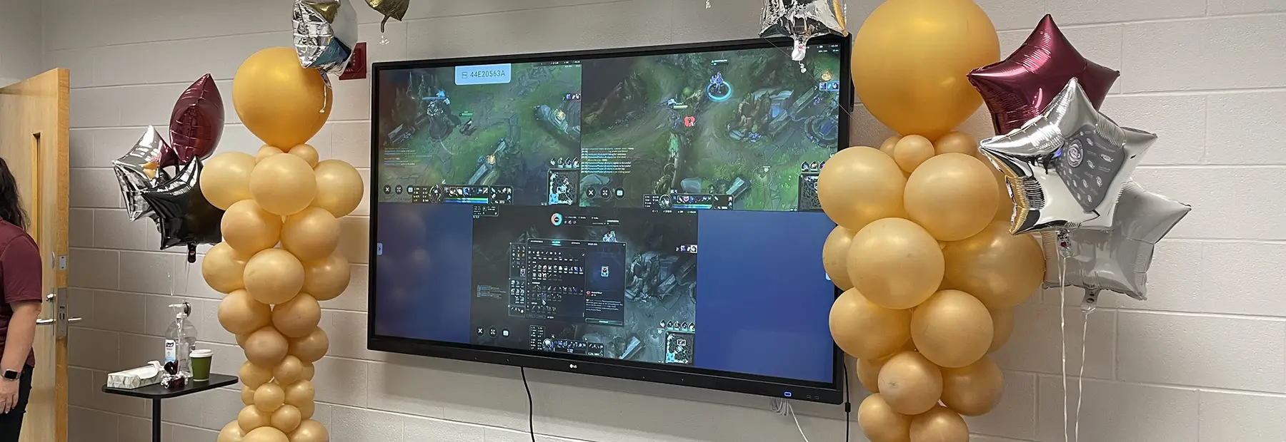 Large gaming display surrounded by balloons